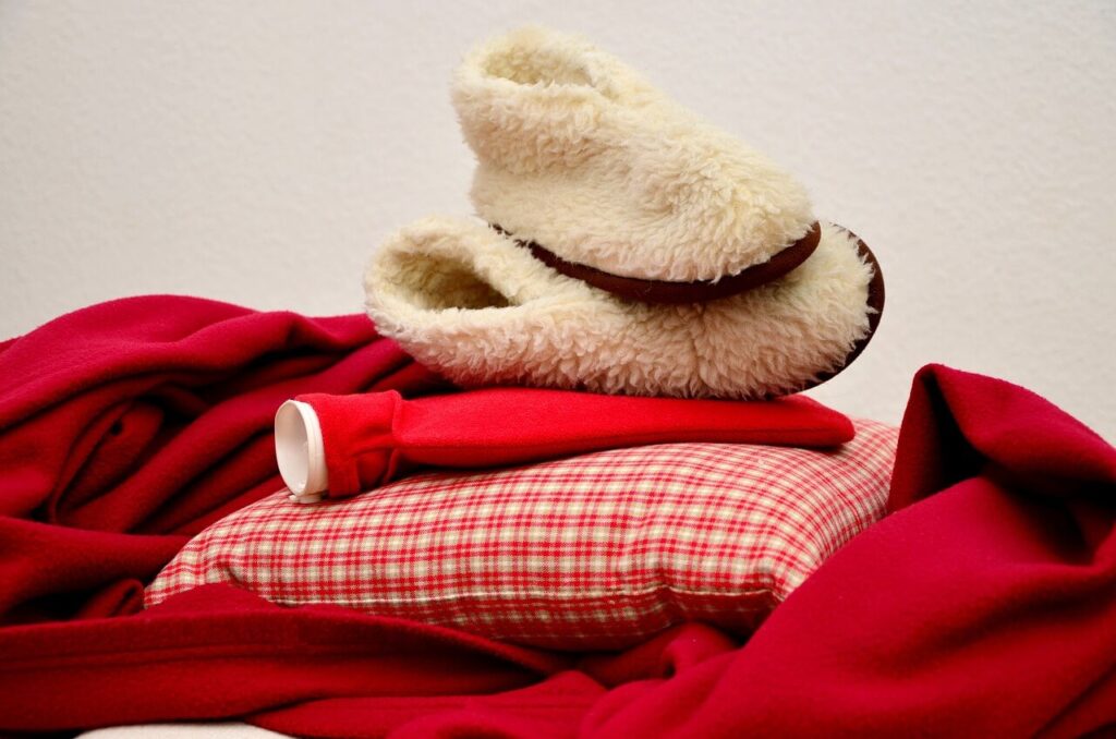 Körnerkissen und Wärmfalsche liegen aufeinander auf einer Decke